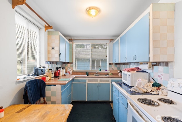 1869 Van Hoesen Rd, Onalaska, WA 98570 - kitchen with white appliances, blue cabinets, light countertops, and decorative backsplash