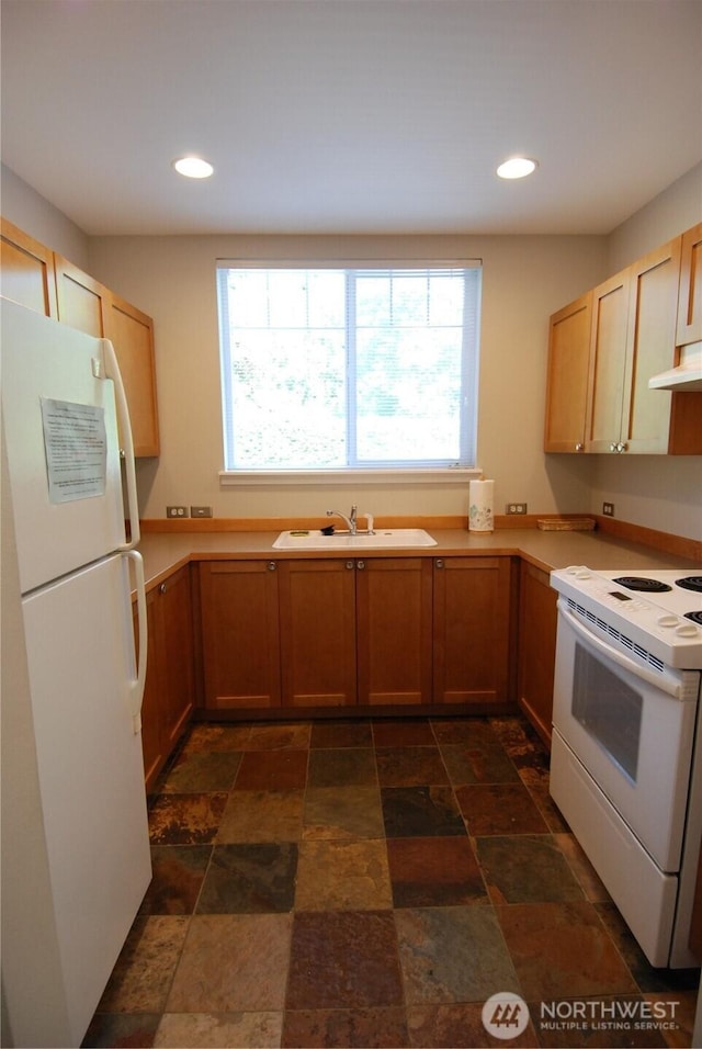 12712 Admiralty Way Unit B202, Everett, WA 98204 - kitchen with white appliances, dark stone finish flooring, recessed lighting, light countertops, and extractor fan