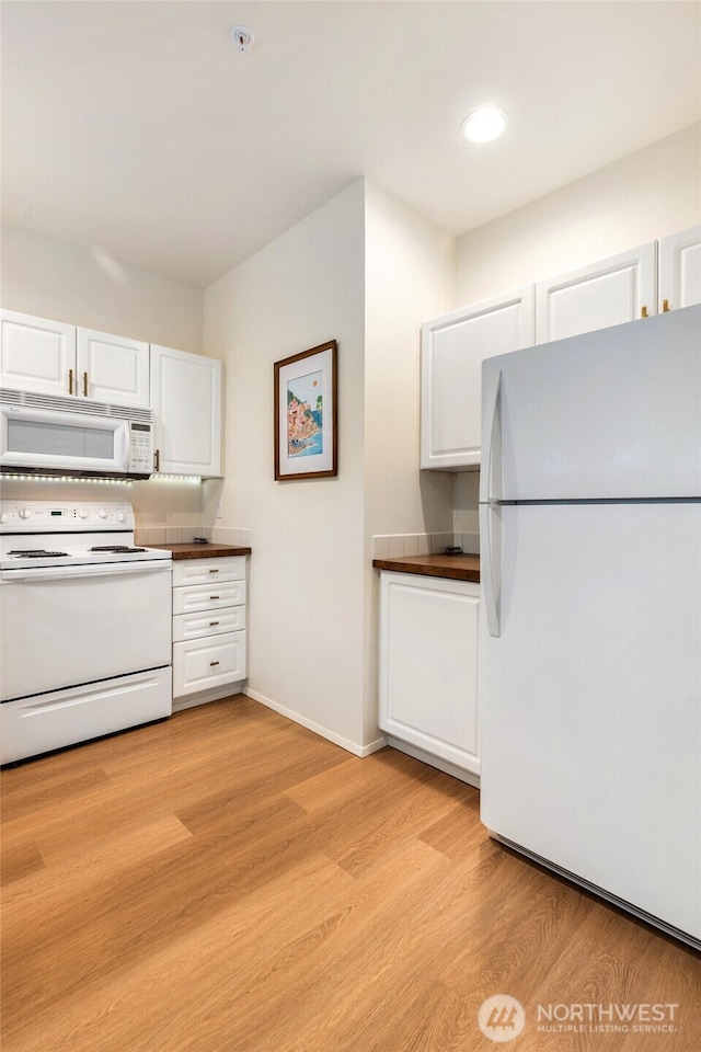 12712 Admiralty Way Unit B202, Everett, WA 98204 - kitchen featuring white appliances, white cabinetry, dark countertops, light wood-type flooring, and recessed lighting