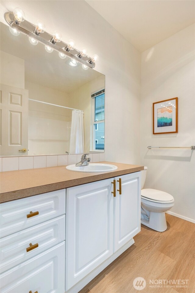 12712 Admiralty Way Unit B202, Everett, WA 98204 - full bathroom featuring wood finished floors, vanity, and curtained shower