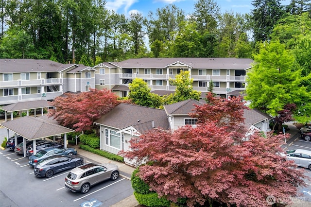 12712 Admiralty Way Unit B202, Everett, WA 98204 - view of building exterior with covered and uncovered parking and a residential view