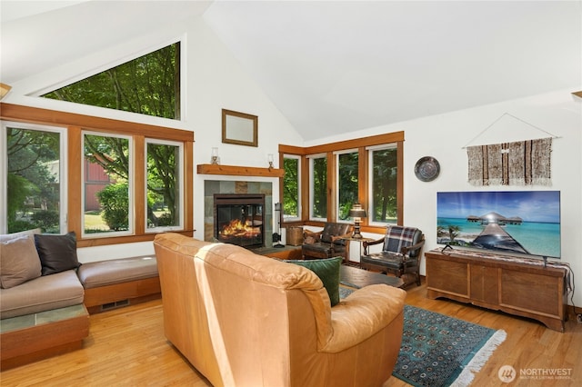 5579 NE Foster Rd, Bainbridge Island, WA 98110 - living area with a fireplace, high vaulted ceiling, and wood finished floors