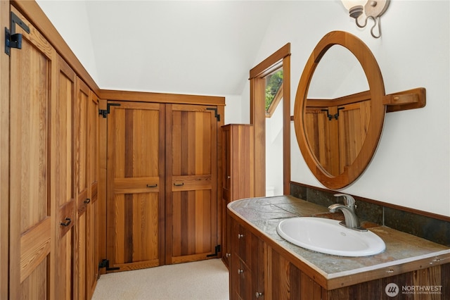 5579 NE Foster Rd, Bainbridge Island, WA 98110 - bathroom featuring vaulted ceiling and vanity