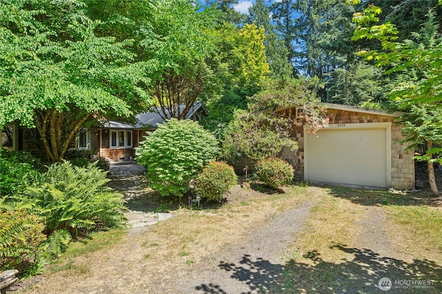 5579 NE Foster Rd, Bainbridge Island, WA 98110 - view of front of house featuring dirt driveway and an attached garage