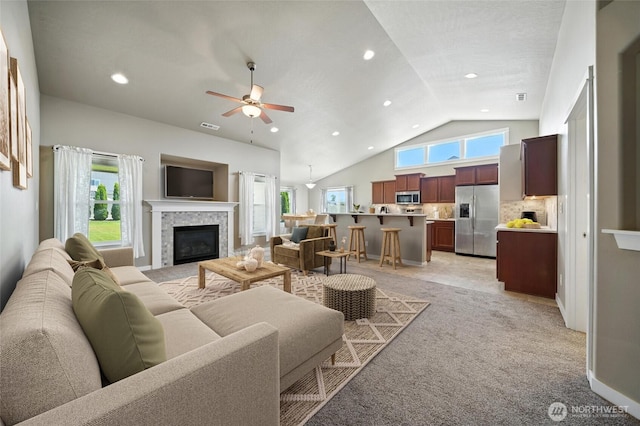 1330 Caprio Loop, Walla Walla, WA 99362 - living area featuring a tile fireplace, ceiling fan, light carpet, vaulted ceiling, and recessed lighting
