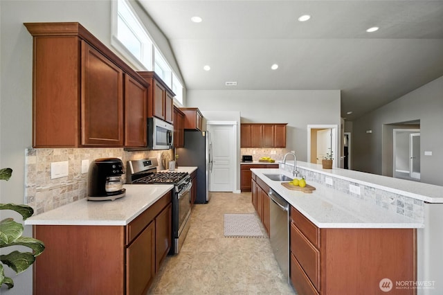 1330 Caprio Loop, Walla Walla, WA 99362 - kitchen with appliances with stainless steel finishes, lofted ceiling, backsplash, recessed lighting, and a spacious island