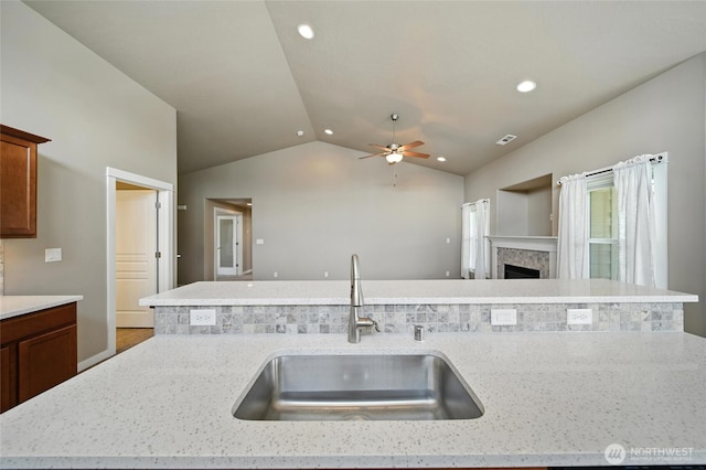 1330 Caprio Loop, Walla Walla, WA 99362 - kitchen with open floor plan, vaulted ceiling, ceiling fan, recessed lighting, and light stone counters