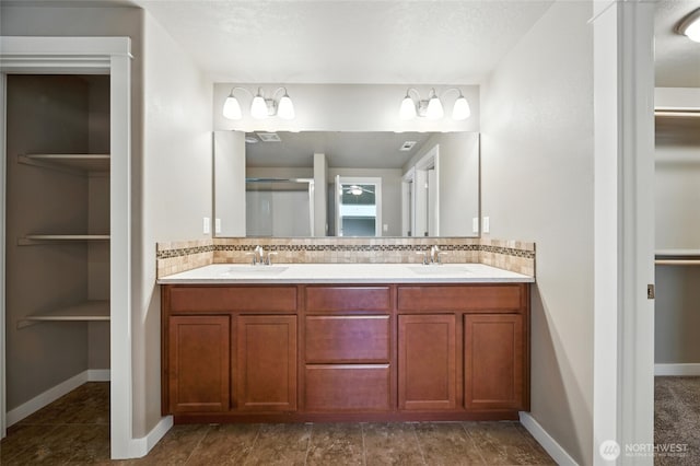 1330 Caprio Loop, Walla Walla, WA 99362 - bathroom featuring double vanity, tasteful backsplash, and a spacious closet