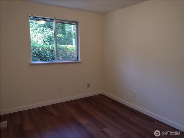 6245 S Huson St, Tacoma, WA 98409 - spare room featuring dark wood-type flooring and baseboards