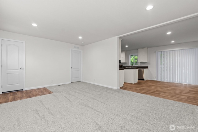 2120 77th Street Ct E, Tacoma, WA 98404 - unfurnished living room with recessed lighting, carpet flooring, and wood finished floors