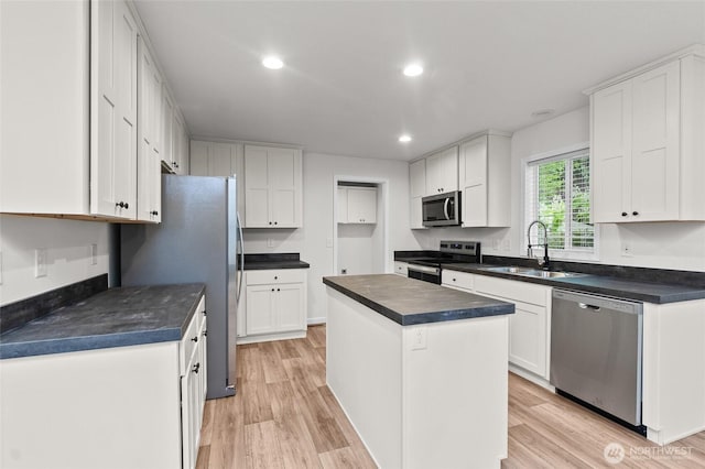2120 77th Street Ct E, Tacoma, WA 98404 - kitchen with stainless steel appliances, dark countertops, light wood-style floors, and recessed lighting