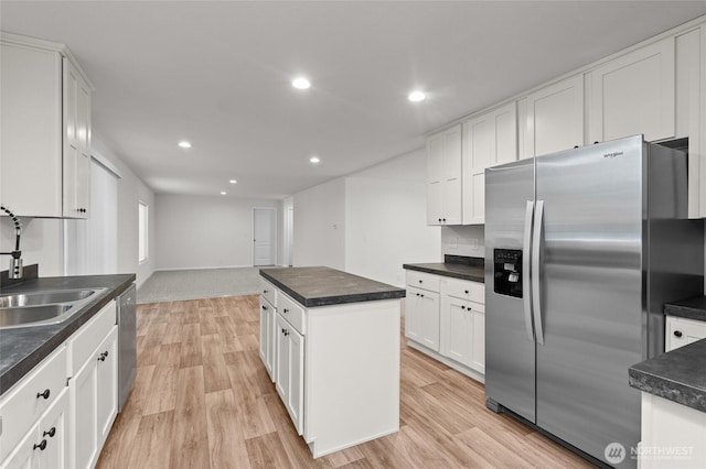 2120 77th Street Ct E, Tacoma, WA 98404 - kitchen with stainless steel appliances, light wood-style flooring, white cabinetry, dark countertops, and recessed lighting