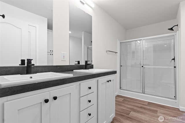 2120 77th Street Ct E, Tacoma, WA 98404 - full bath with double vanity, wood finished floors, and an enclosed shower