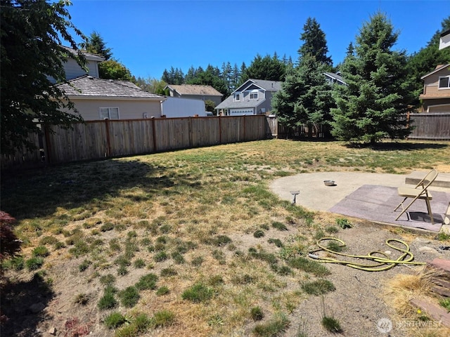 7106 201st St E, Spanaway, WA 98387 - fenced backyard with a patio area and a residential view