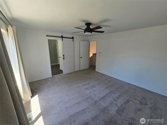 7106 201st St E, Spanaway, WA 98387 - unfurnished bedroom with carpet, a ceiling fan, and a barn door