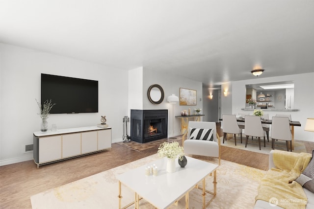 500 W Roy St Unit W103, Seattle, WA 98119 - living room with wood finished floors and a multi sided fireplace