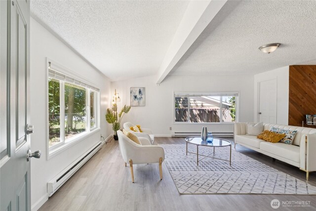 19520 Grannis Rd, Bothell, WA 98012 - living area with a baseboard radiator, a textured ceiling, plenty of natural light, wood finished floors, and beamed ceiling