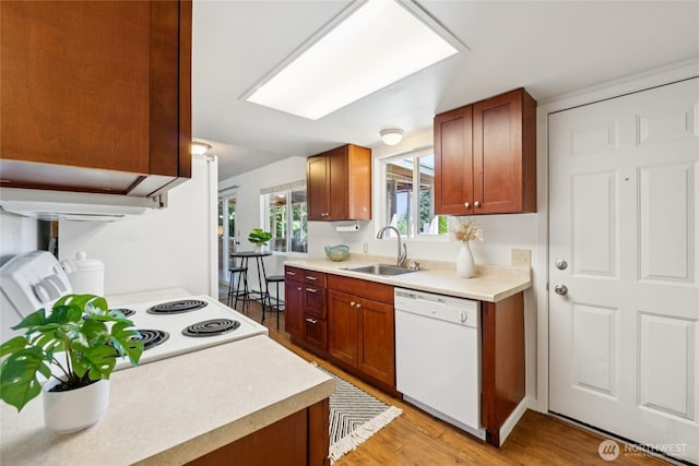 19520 Grannis Rd, Bothell, WA 98012 - kitchen with white appliances, light countertops, light wood-type flooring, and brown cabinets