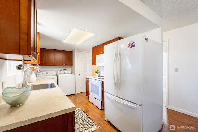 19520 Grannis Rd, Bothell, WA 98012 - kitchen featuring white appliances, separate washer and dryer, light countertops, and light wood-style floors