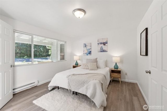 19520 Grannis Rd, Bothell, WA 98012 - bedroom featuring a baseboard heating unit and wood finished floors