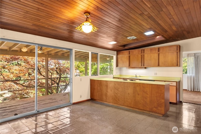 4728 86th Ave SE, Mercer Island, WA 98040 - kitchen featuring a peninsula, brown cabinets, and light countertops