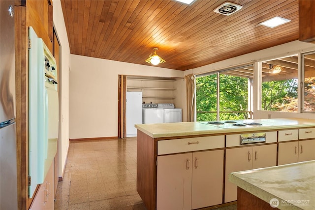 4728 86th Ave SE, Mercer Island, WA 98040 - kitchen with washer and clothes dryer, light flooring, light countertops, white appliances, and wooden ceiling