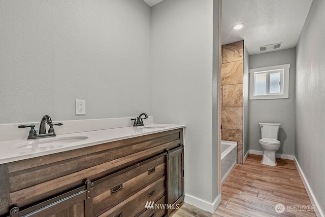 970 9th Ave, Longview, WA 98632 - bathroom with double vanity, wood finished floors, and shower / washtub combination