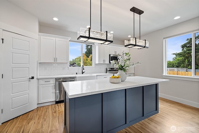 10111 12th Ave E, Tacoma, WA 98445 - kitchen with stainless steel appliances, healthy amount of natural light, backsplash, white cabinets, and recessed lighting