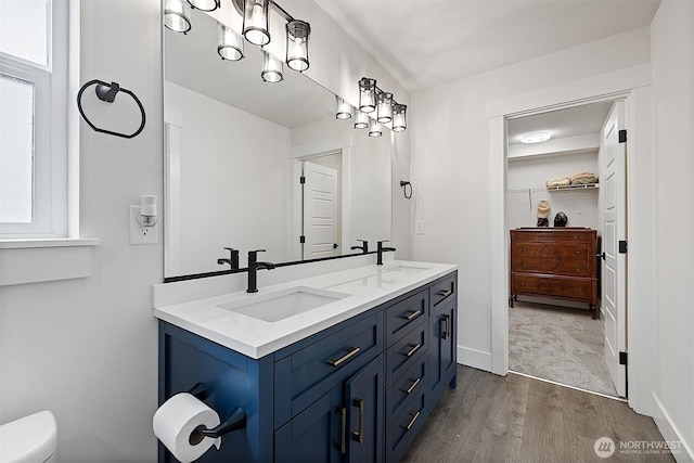 10111 12th Ave E, Tacoma, WA 98445 - bathroom with double vanity, wood finished floors, and a spacious closet