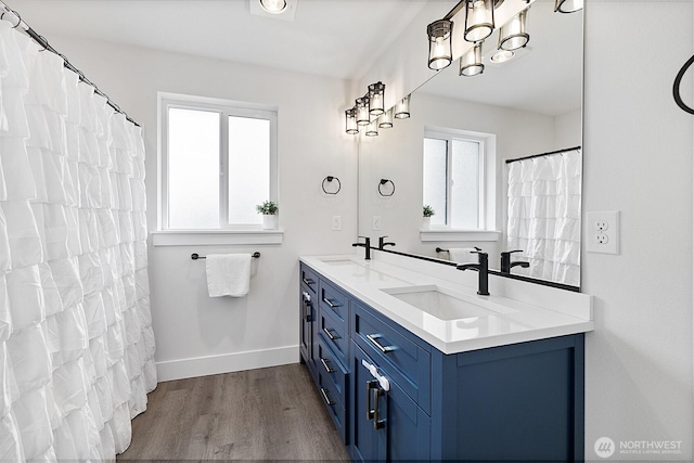 10111 12th Ave E, Tacoma, WA 98445 - full bath with healthy amount of natural light, wood finished floors, and double vanity