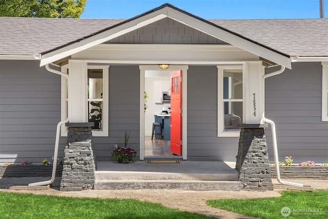 7554 34th Ave SW, Seattle, WA 98126 - view of exterior entry featuring covered porch and a shingled roof