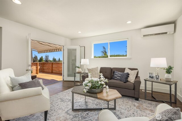 7554 34th Ave SW, Seattle, WA 98126 - living area featuring a wall unit AC, healthy amount of natural light, wood finished floors, and recessed lighting