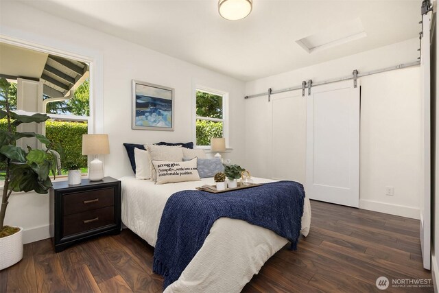 7554 34th Ave SW, Seattle, WA 98126 - bedroom featuring a barn door and dark wood-style floors