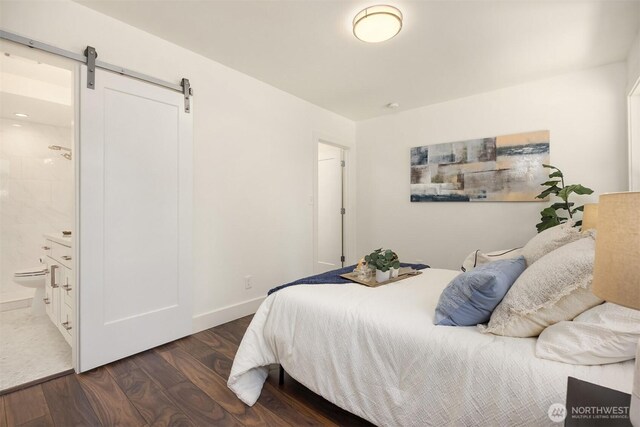 7554 34th Ave SW, Seattle, WA 98126 - bedroom with a barn door, wood finished floors, and connected bathroom