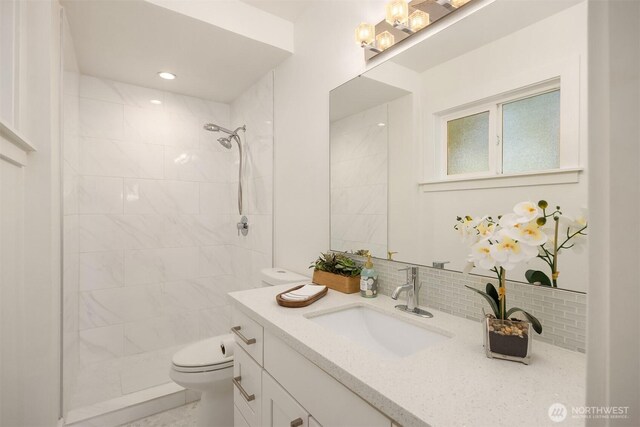 7554 34th Ave SW, Seattle, WA 98126 - full bathroom featuring vanity, a tile shower, and backsplash