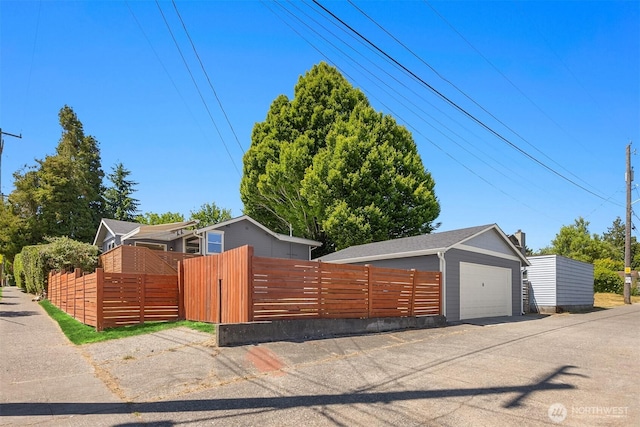 7554 34th Ave SW, Seattle, WA 98126 - view of front of property with a fenced front yard, an outbuilding, a garage, and a gate