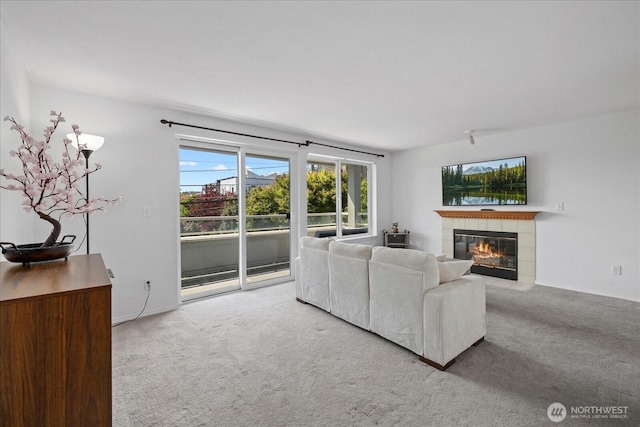 2448 NW 59th St Unit 301, Seattle, WA 98107 - carpeted living area with a tiled fireplace