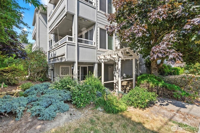 2448 NW 59th St Unit 301, Seattle, WA 98107 - rear view of property with a balcony, a sunroom, and a chimney