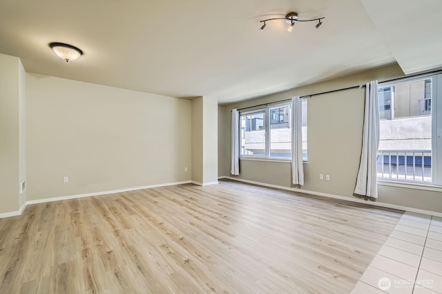 76 Cedar St Unit 806, Seattle, WA 98121 - unfurnished room with light wood-style floors and baseboards
