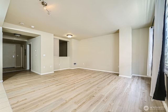 76 Cedar St Unit 806, Seattle, WA 98121 - empty room with light wood-style floors and baseboards
