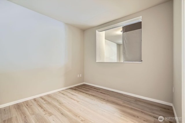 76 Cedar St Unit 806, Seattle, WA 98121 - spare room with baseboards and wood finished floors