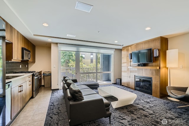 76 Cedar St Unit 806, Seattle, WA 98121 - living area with a tiled fireplace, recessed lighting, and light tile patterned flooring