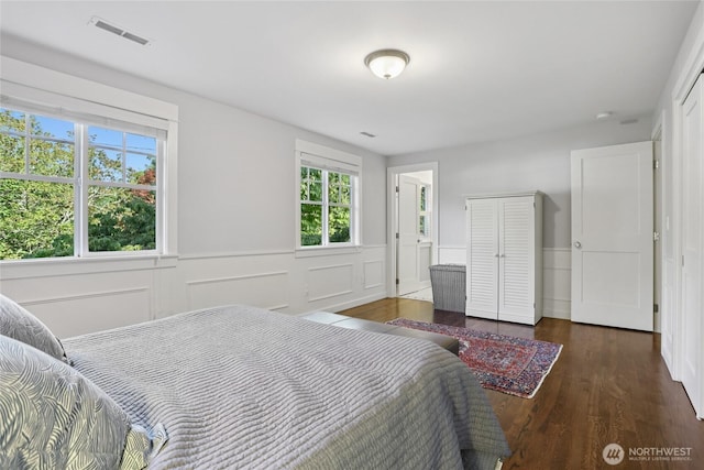 4712 90th Ave SE, Mercer Island, WA 98040 - bedroom featuring a wainscoted wall, wood finished floors, multiple windows, and a closet