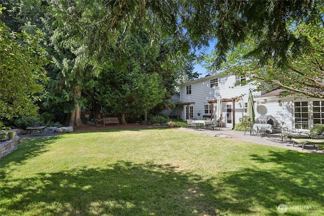 4712 90th Ave SE, Mercer Island, WA 98040 - view of grassy yard with a patio area and french doors