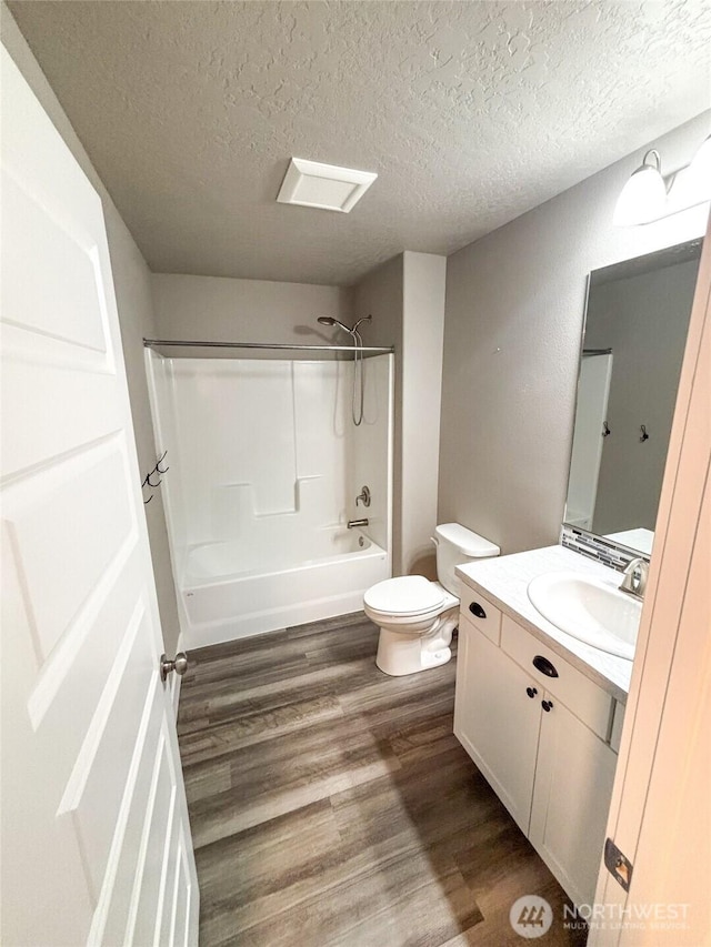 1522 E Marilyn Cir, Deer Park, WA 99006 - bathroom featuring vanity,  shower combination, wood finished floors, and a textured ceiling