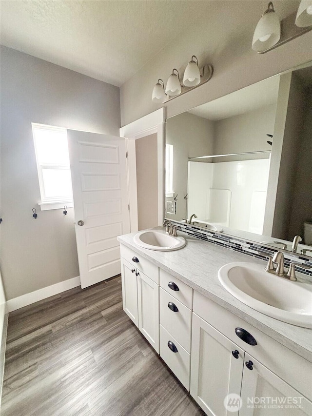 1522 E Marilyn Cir, Deer Park, WA 99006 - bathroom with a shower, double vanity, wood finished floors, and a textured ceiling