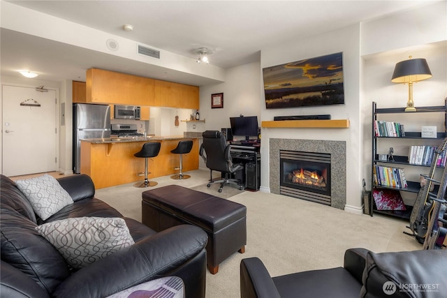 1420 Terry Ave Unit 1607, Seattle, WA 98101 - carpeted living room featuring a glass covered fireplace