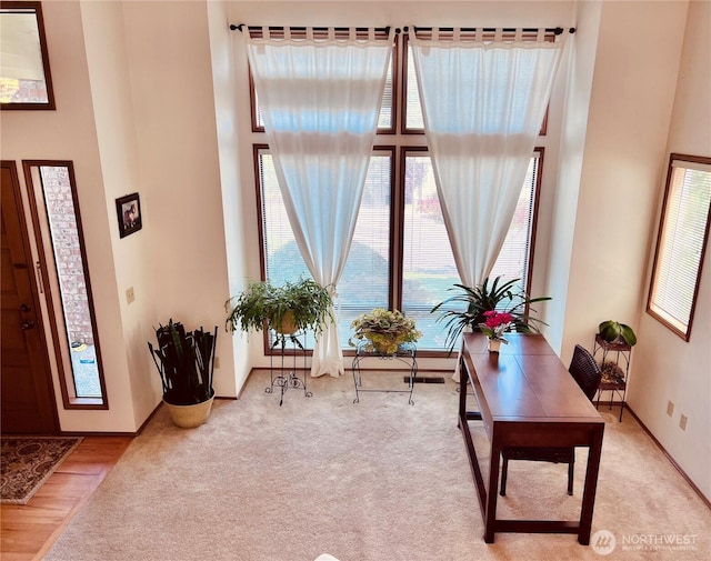 8123 129th Pl SE, Newcastle, WA 98056 - carpeted home office featuring healthy amount of natural light and a towering ceiling