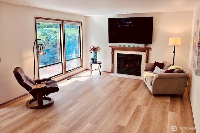 8123 129th Pl SE, Newcastle, WA 98056 - living area featuring light wood-type flooring and a tile fireplace