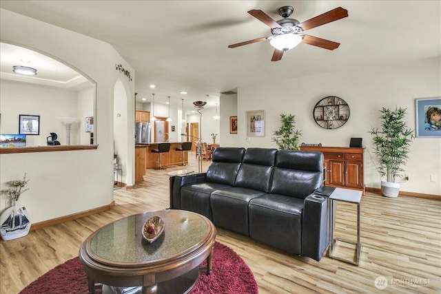 15203 148th Avenue Ct E, Orting, WA 98360 - living area featuring light wood-type flooring, a ceiling fan, arched walkways, and recessed lighting